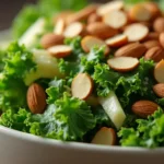 Fresh homemade kale salad with almonds and apple